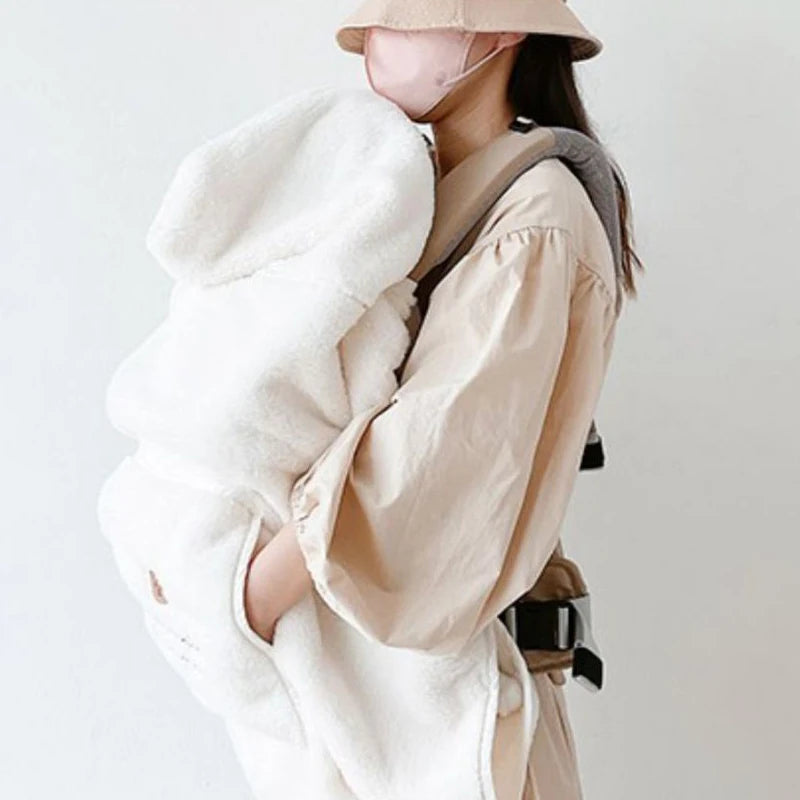 white hooded coat and beige trench coat on a plain background